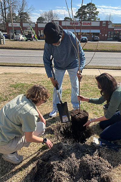 Batten University students and community members planting native trees in Portsmouth.