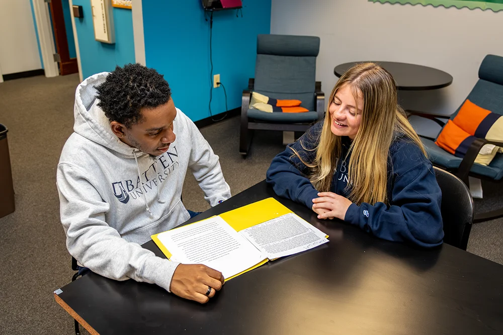 Student meeting with an academic advisor in Clarke Hall