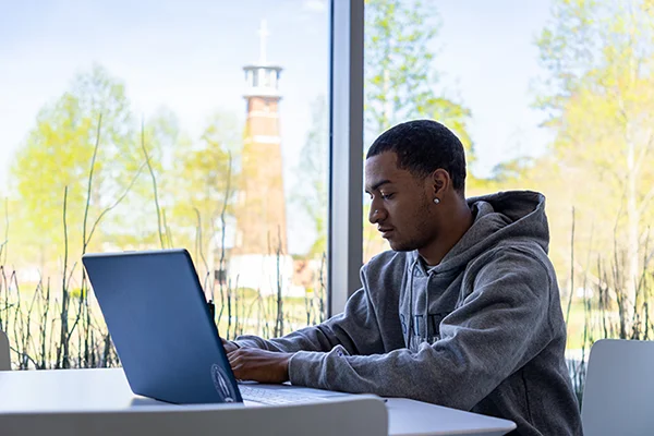 Student working on laptop for online courses